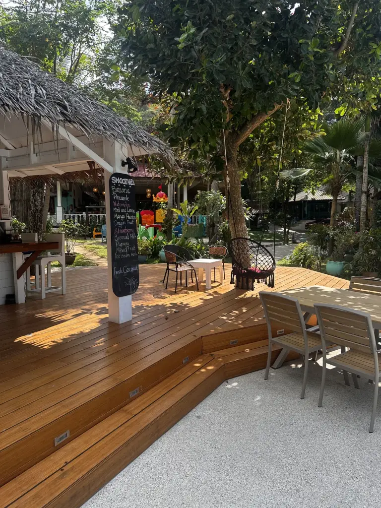 Wooden deck and seating areas in the tropical garden at Baan Kiao Resort