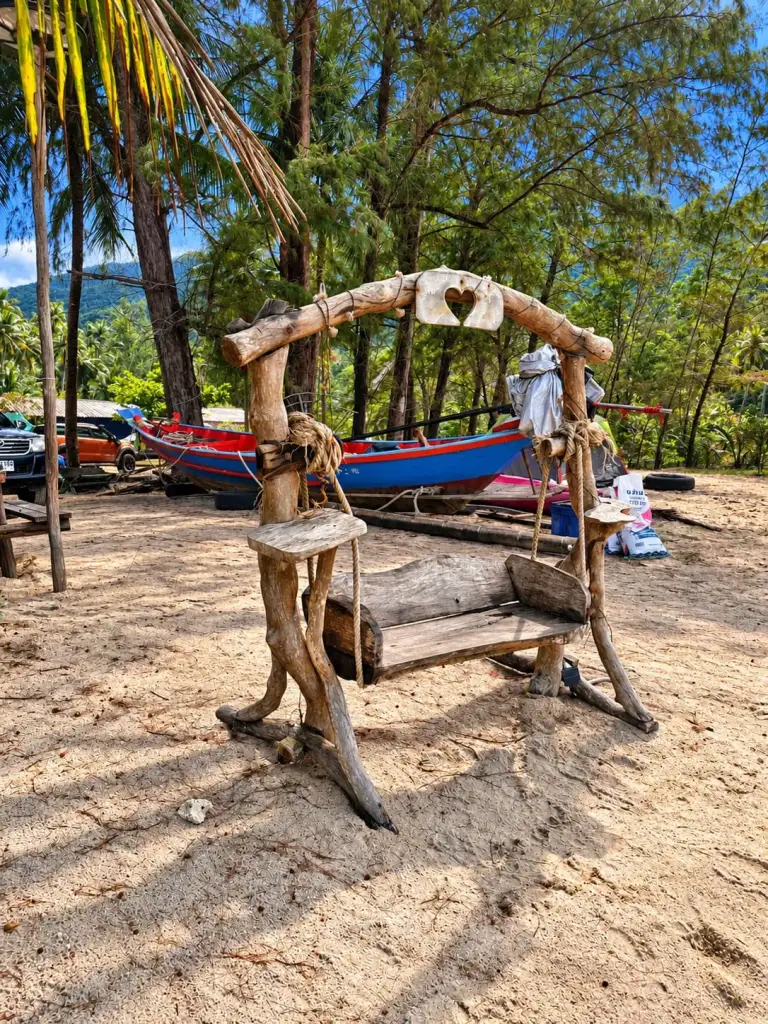 A wooden swing on the sand at Bottle Beach