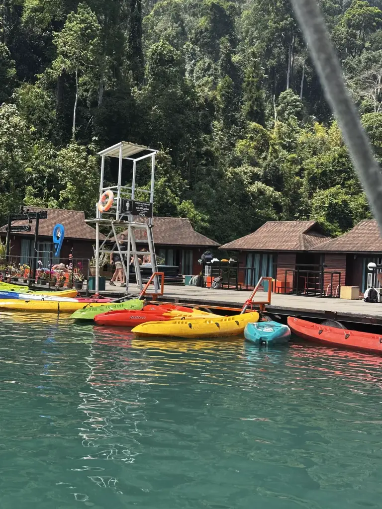 Colourful kayaks next to the floating huts on Cheow Lan Lake