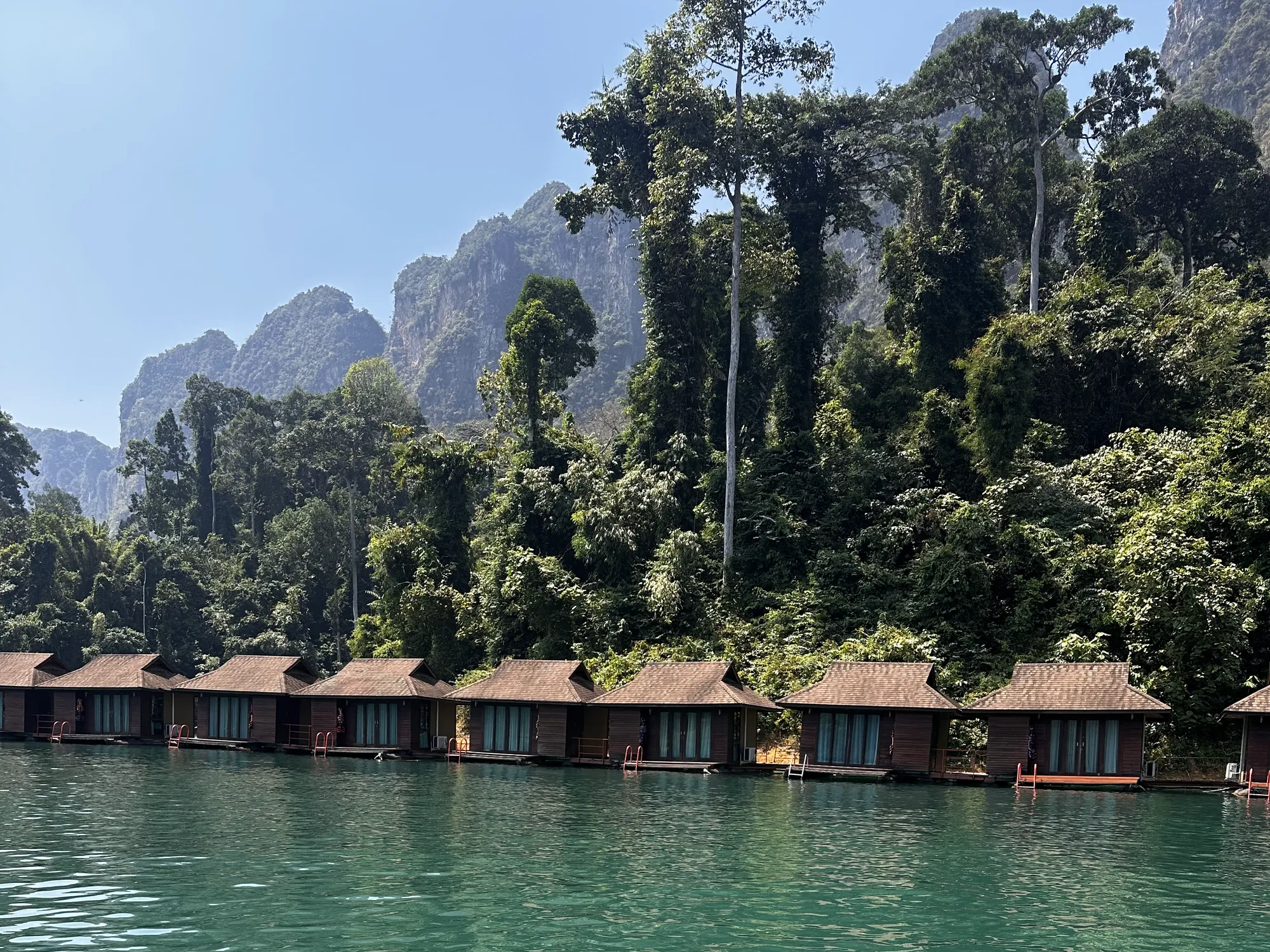 Floating huts facing the jungle and limestone cliffs on Cheow Lan Lake