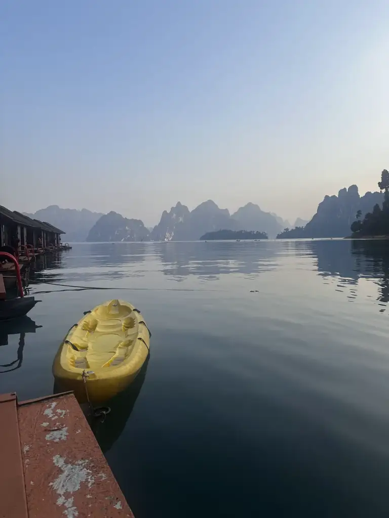 Yellow kayak next to the deck, Cheow Lan Lake towards evening