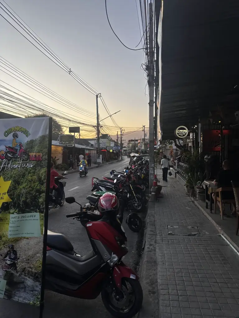 Scooters parked as evening falls in Chiang Mai