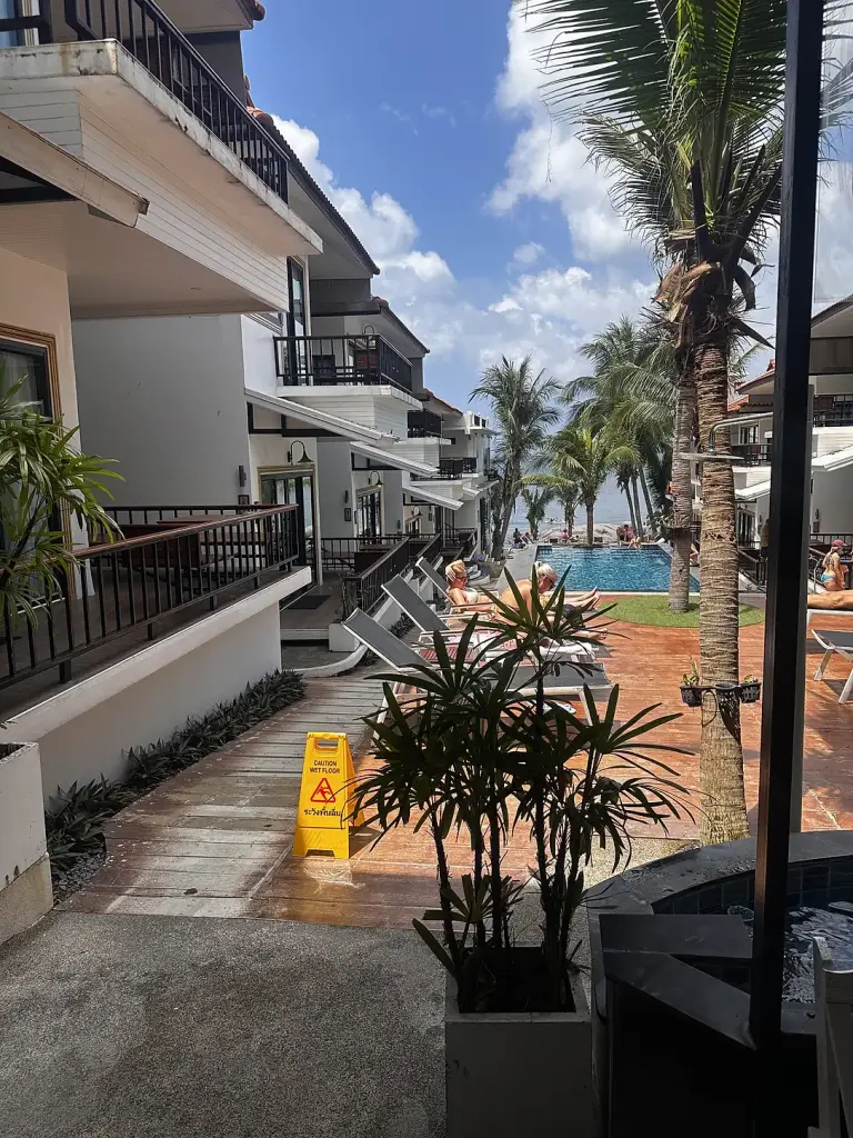 The pool at Clear View Resort running alongside the rooms, with the sea behind