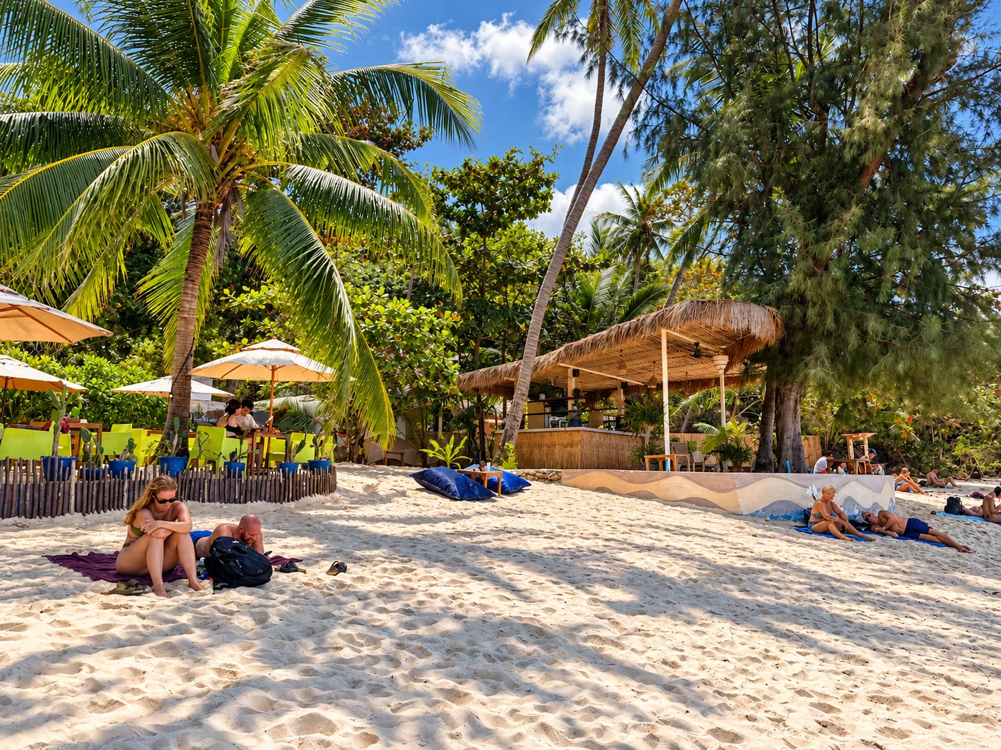 Palm trees and parasols on the sand at Haad Yao beach, Koh Phangan