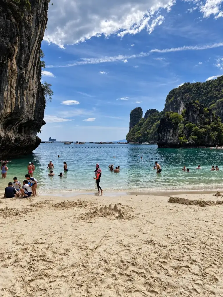 Swimmers on the beach at Koh Hong between the limestone cliffs