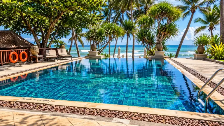Sea-facing pool at Impiana Resort Chaweng Noi among the palm trees, Koh Samui