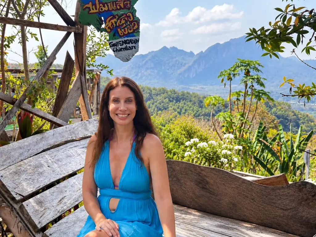 Michelle on the heart-shaped wooden bench at Uncle Khiao Passion Fruit Garden, near Ratchaprapha Dam in Khao Sok