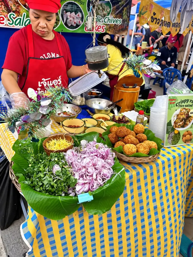 Salad and fried snacks stall at the Chaloklum Sunday market