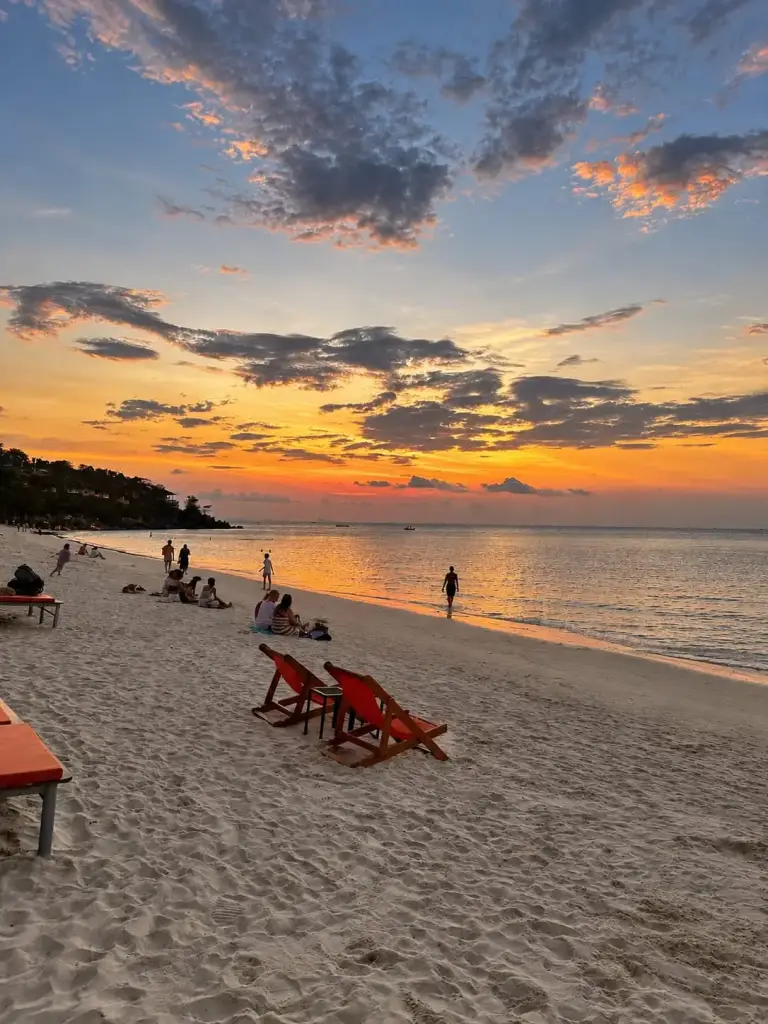 Orange sunloungers on the sand at sunset, Haad Yao beach, Koh Phangan