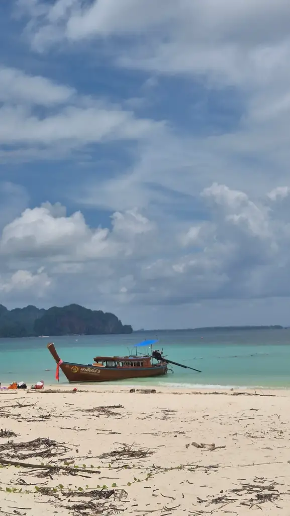 A longtail boat on the beach at Koh Poda in Krabi