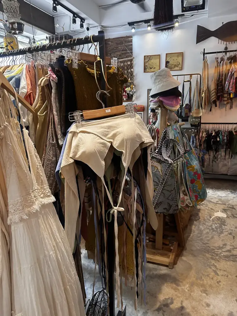 A clothing boutique in Sairee with dresses in natural shades and hats