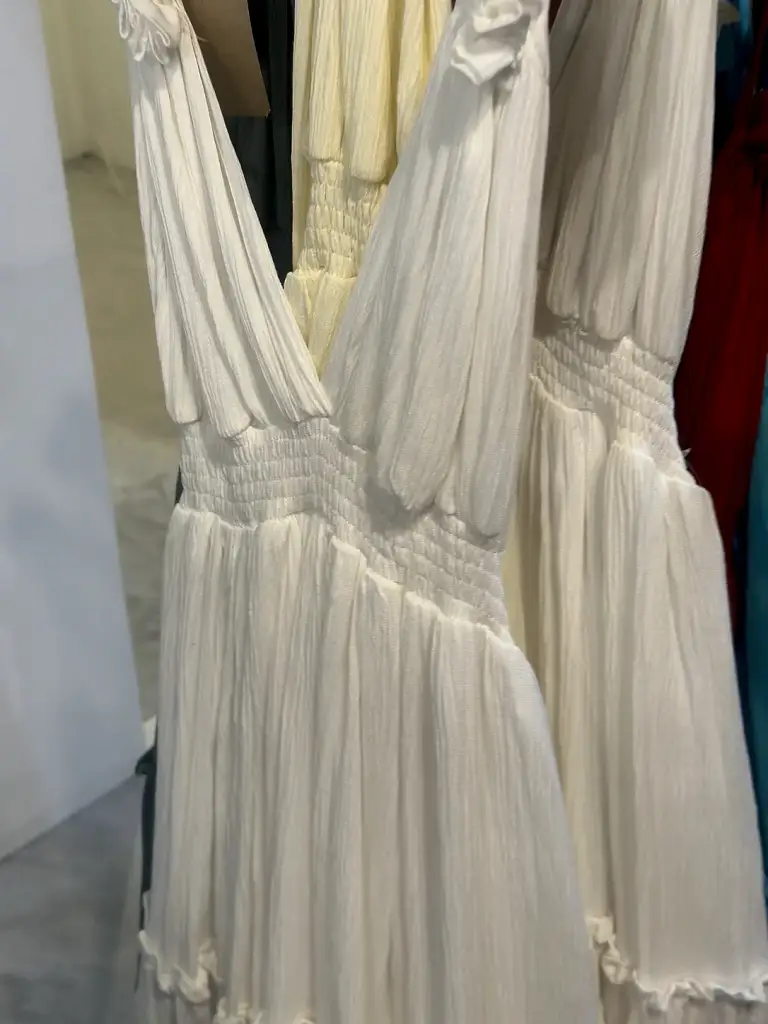 A long cream dress with ruffles in a shop on Koh Tao