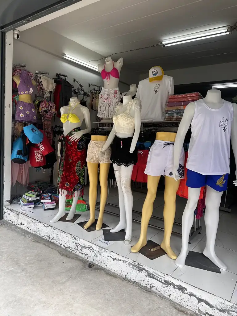 Swimwear and tops on mannequins in a shop in Sairee