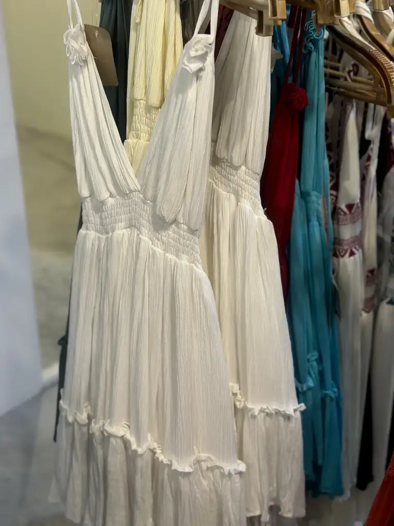 A long white V-neck dress in a shop on Koh Tao