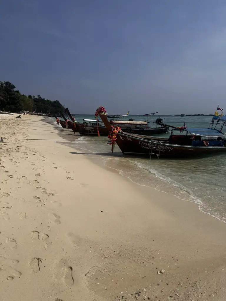 A beach with longtail boats on the way to Long Beach on Koh Phi Phi