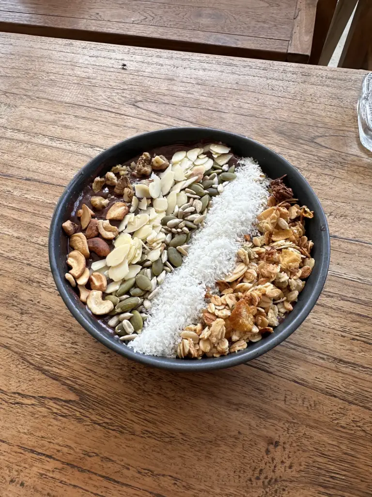 A vegan coconut yoghurt bowl with granola, nuts, seeds and coconut flakes at Pura Vida