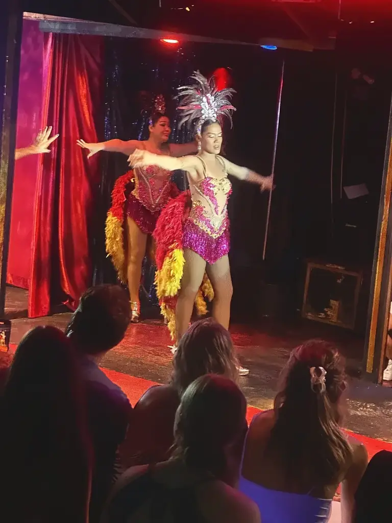 Dancers in feathered costumes and headdresses on stage at Queen's Cabaret, Koh Tao