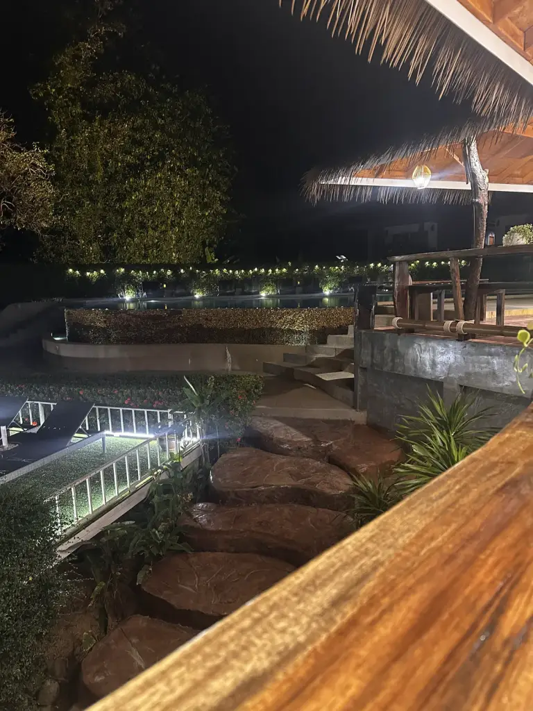 Railay Phutawan Resort in the evening: the pool and lit-up balconies