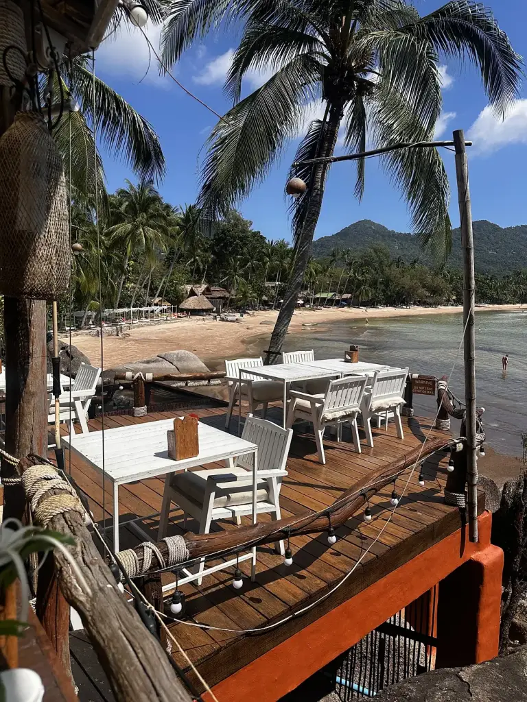 White tables facing the sea on the Rim Lae deck