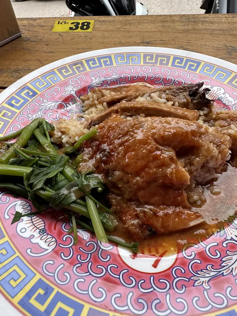 A plate of rice with duck and vegetables at a local restaurant in Sairee