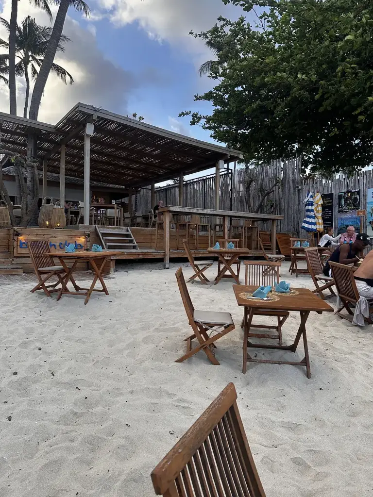 A bar with tables on the sand at Buri Rasa Village