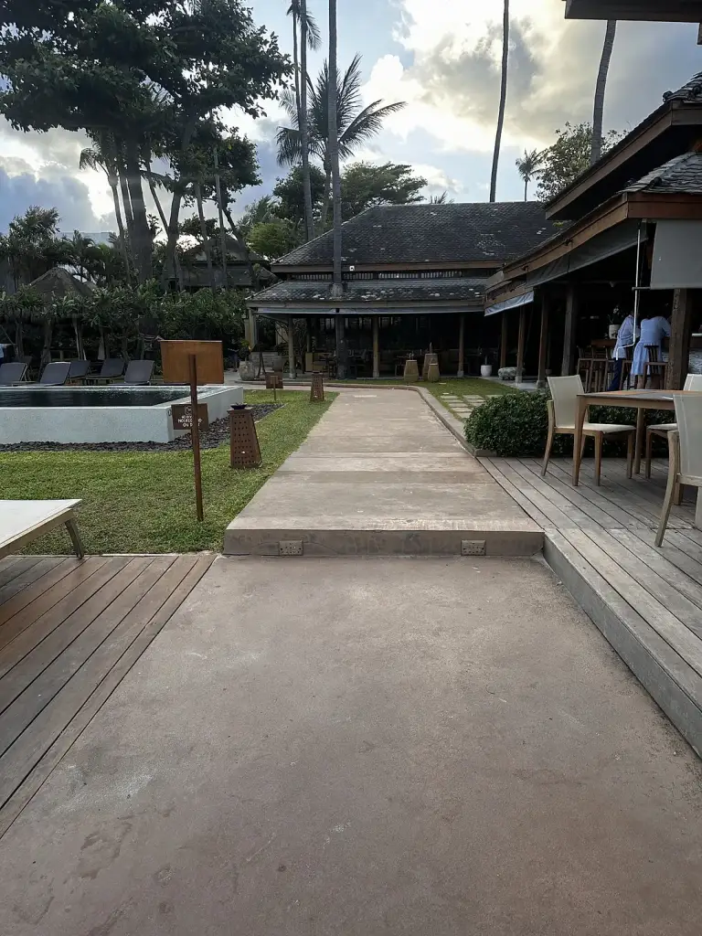 A path and lawn between the pavilions at Buri Rasa