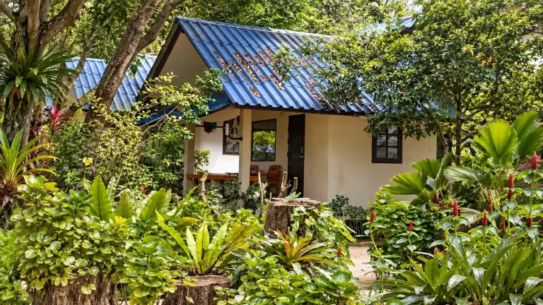 Blue-roofed bungalow among tropical greenery at SB Cabana, Koh Tao