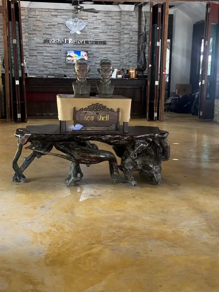 The Thai-style lobby at Seashell Resort, with a carved wooden table