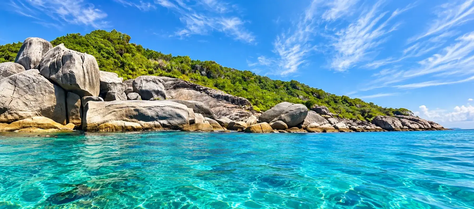Huge granite boulders and clear turquoise water in the Similan Islands