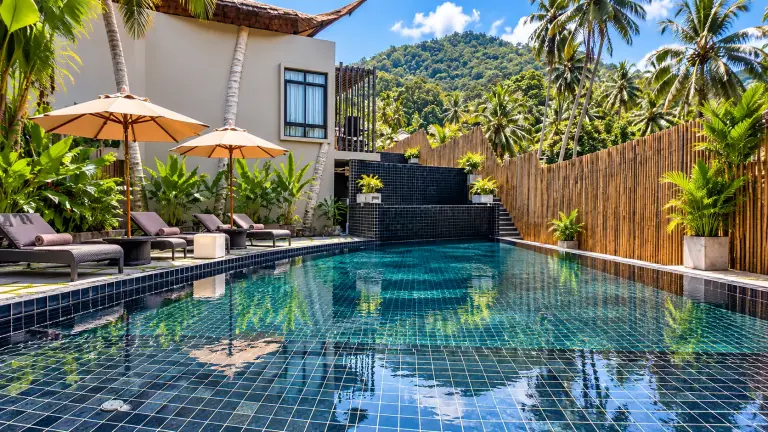 Hilltop pool at The Tarna Align Resort above Sairee, with sunloungers and green hills, Koh Tao