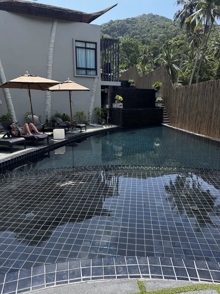 A pool with parasols and sun loungers at The Tarna Align Resort