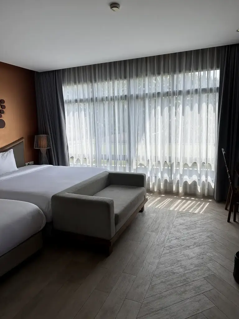 The large window and the sofa in the room at The Tarna Align Resort
