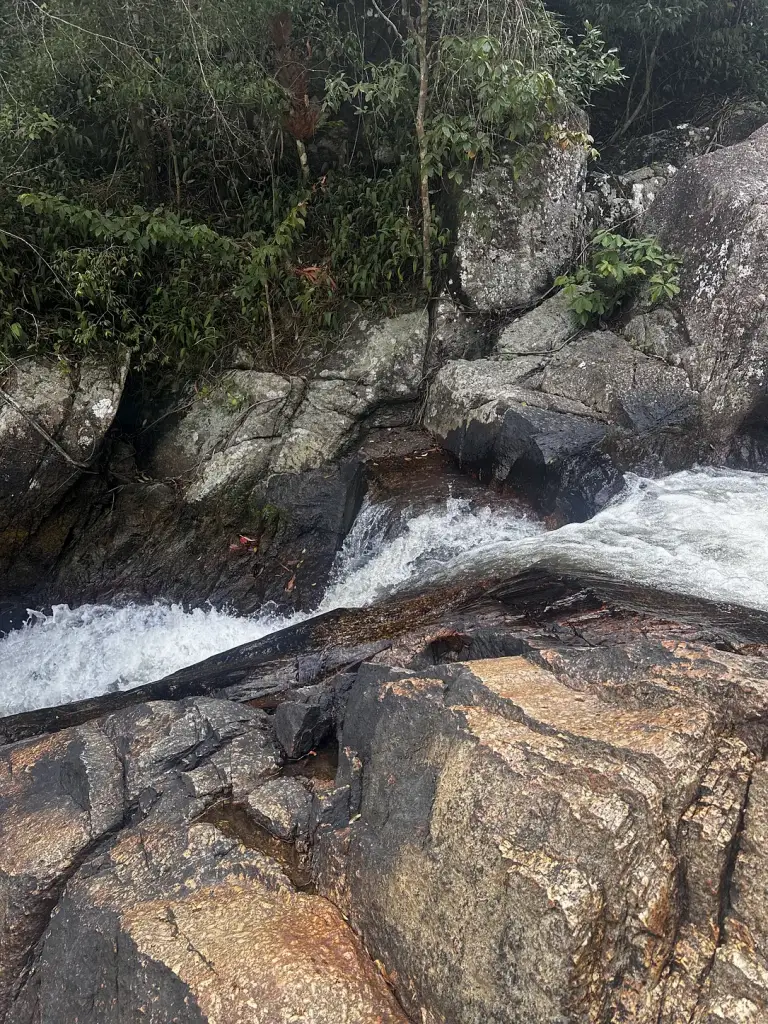 Water flowing over the rock steps of the Than Sadet stream