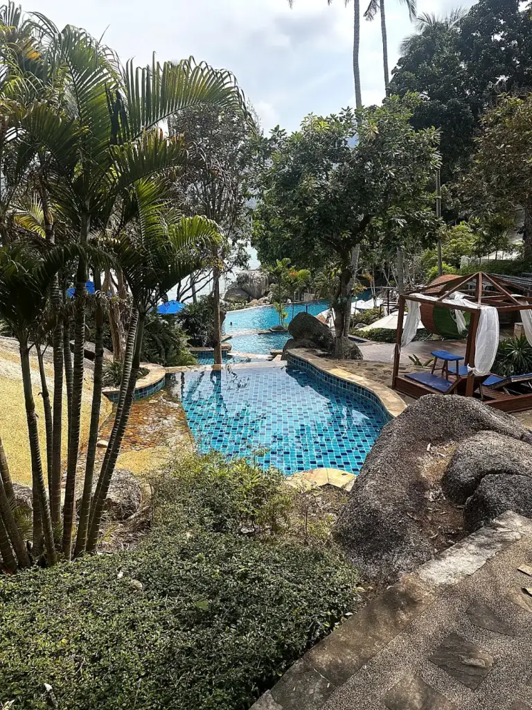 Panviman Resort's infinity pool among the trees, above the sea